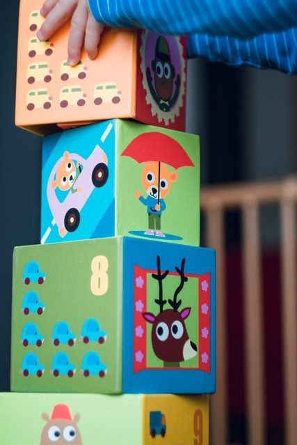 A child stacking large blocks.